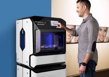 An engineer using Stratasys' DentaJet J5 3D printer. Photo via Stratasys.