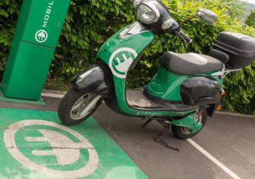 An electric scooter being charged.